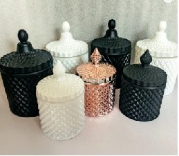 Detailed view of geometric glass jars with lids in matte black, white, and rose gold finish