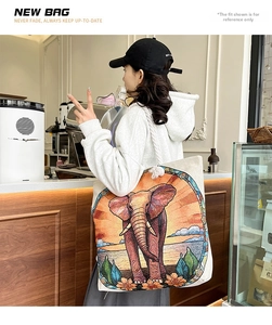 Lifestyle view of canvas tote bag with colorful elephant print and cotton rope handle
