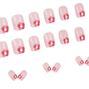 Pink press-on nails with red flower patterns in a glossy short round style