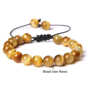 Detail of 8mm tiger eye beads with silk luster on adjustable braided cord bracelet