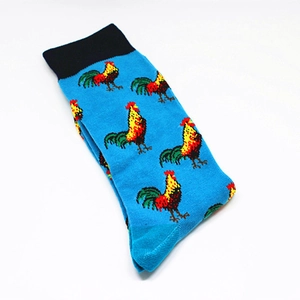 Detail of blue crew socks with colorful rooster print and black ribbed cuffs