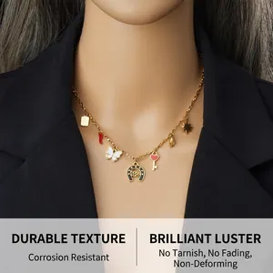 Detail of gold chain necklace featuring multi-charms like elephant, heart and good luck tag