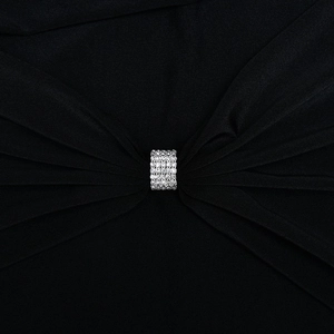 Detail of elegant black pleated fabric with a rectangular silver rhinestone buckle design