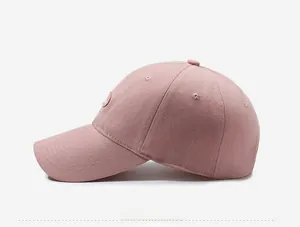 Side view of pink cotton baseball cap featuring classic six-panel design and embroidered eyelets