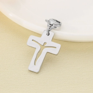 Detailed view of polished stainless steel hollow crucifix pendant with lobster clasp attachment
