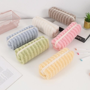 Close-up of colorful plush pencil cases with striped texture and durable zipper detail