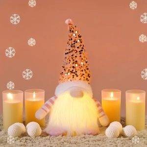 Close-up of a glowing Christmas gnome with gold sequin hat and warm LED lights