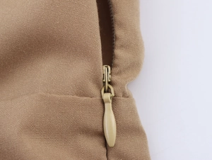 Detailed view of a khaki dress featuring a high-quality invisible zipper and twill fabric
