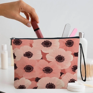 Floral canvas makeup bag with zipper and hand strap, showing lipstick storage scene