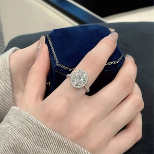Macro detail of silver halo ring with oval moissanite and micro-pave setting