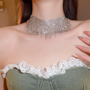Close-up of sparkling rhinestone choker necklace with layered mesh and tassel details