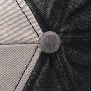 Macro shot of baseball cap crown with two-tone fabric stitching and top button detail