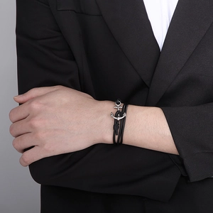 Detail of silver anchor clasp on multi-layer black leather wrap bracelet for men