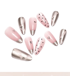 Detail of 10-piece almond press-on nails with pink cat eye, silver mirror, and rhinestones