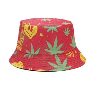 Reversible red bucket hat with green cannabis leaves and melting smiley face graphics