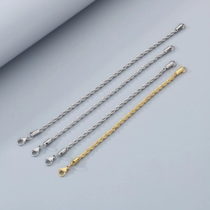 Detail of twisted rope chains in gold and silver steel with lobster clasp closures
