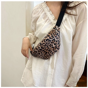 Close-up of leopard print canvas chest bag worn across the chest on a white shirt