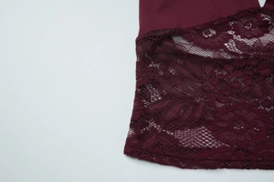 Detail of the intricate lace texture and wine red stitching on the sheer tube top