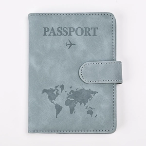 Close-up of gray-blue RFID passport holder featuring embossed map and aircraft design