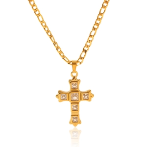 Detailed view of a gold Figaro chain necklace with a cross pendant set with square zircons