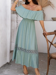Detailed view of light green off-shoulder dress featuring ruffle neckline and lace hem