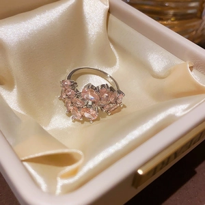 Close-up of pink teardrop zircon stones in a cluster setting on a silver ring band