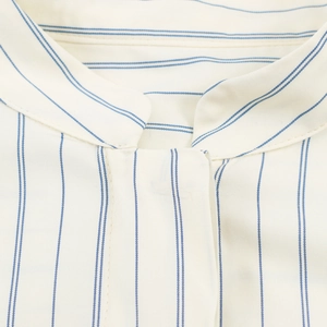 Close-up of blue stripes on cream cotton fabric showing fine stitching and texture