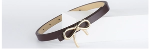 Close-up of a brown slim PU leather belt featuring an elegant gold bow-shaped metal buckle