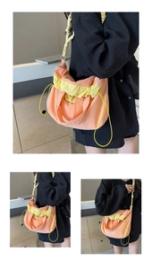 Dettaglio della grande borsa a secchiello in nylon arancione e giallo con coulisse a contrasto