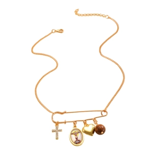 Close-up of golden paperclip necklace featuring cross, heart, and religious medal pendants