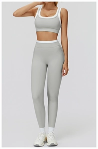 Front view of two-piece grey contrast trim yoga set with high waist leggings and sports bra