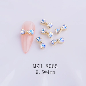 Detailed close-up of aurora heart bow nail charms MZH-8065 with metal base on nail