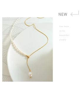 Detail of freshwater pearl and gold snake chain necklace with an adjustable slider bead