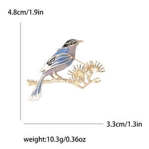 Detailed size view of enamel magpie brooch on pine branch with metric and imperial units