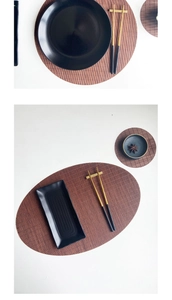 Detail of woven bamboo tea mats in dark brown with elegant black ceramic tableware