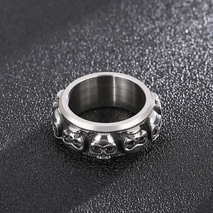 Macro shot of wide punk skull ring with embossed skeletal patterns in vintage silver steel
