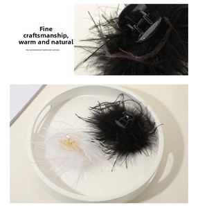 Close-up of elegant ostrich feather hair claws in black and white with fluffy texture