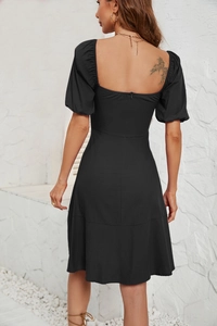 Close-up back view of a black slim-fit dress with square neck and bubble sleeves