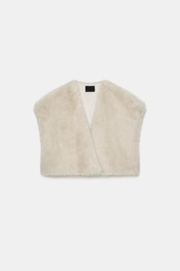 Close-up of soft off-white faux mink fur texture on a cropped winter vest for women