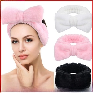 Soft flannel bow headbands with OMG embroidery in pink, white, and black for skincare