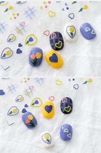 Detail of 3D embossed nail stickers featuring tulip and heart patterns on manicured nails