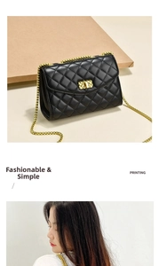 Detail of black quilted chain bag with gold metal lock and diamond pattern texture