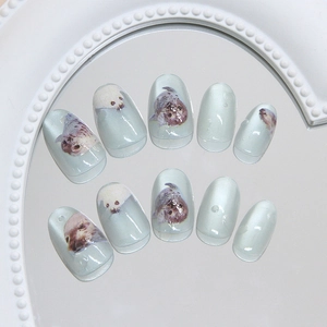 Cat eye blue press on nails with cute seal patterns and glossy oval shape