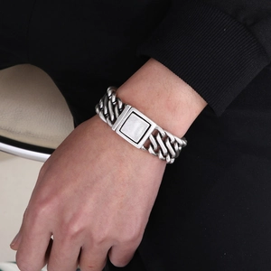 Close-up of vintage silver stainless steel curb chain bracelet on male wrist