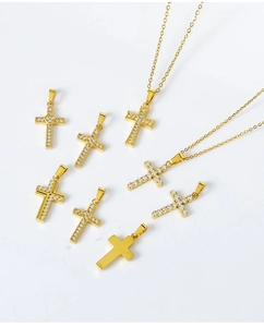 Detailed close-up of gold cross pendants with sparkling zircons on white background
