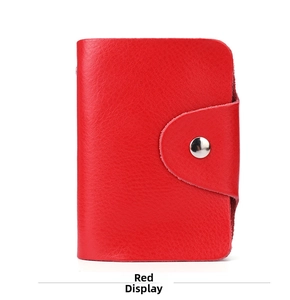 Close-up of a red genuine leather card holder with litchi texture and silver snap button