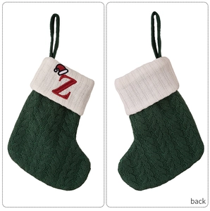 Front and back detail of a green knit Christmas stocking with red letter Z embroidery