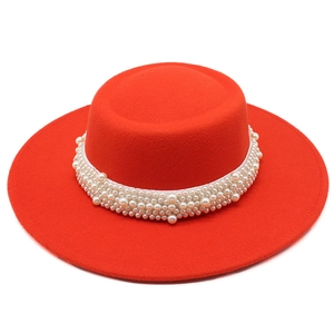 Detailed view of red wool felt boater hat featuring luxury faux pearl embellishments