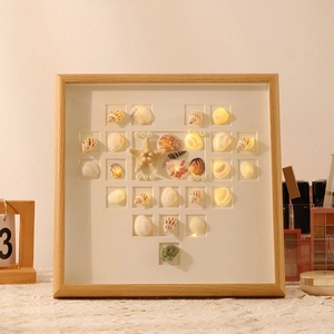DIY shell heart shadow box frame with warm LED lights and assorted natural sea shells