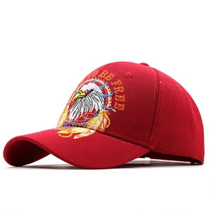 Red baseball cap with eagle embroidery and Born to Be Free slogan, structured wide brim